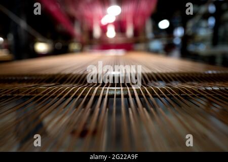 Golden thread on a vintage loom at the historical Bevilacqua weaving in Venice since 1875. Stock Photo