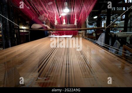 Golden thread on a vintage loom at the historical Bevilacqua weaving in Venice since 1875. Stock Photo