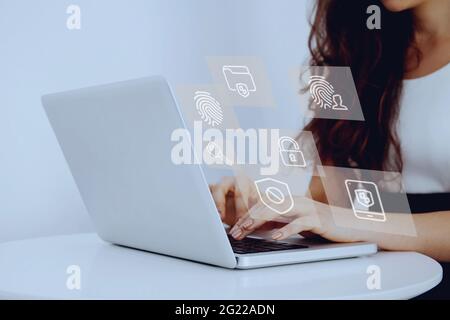 Selective focus of hands of young female businesswoman using laptop while saving security measures against theft and hacking Stock Photo