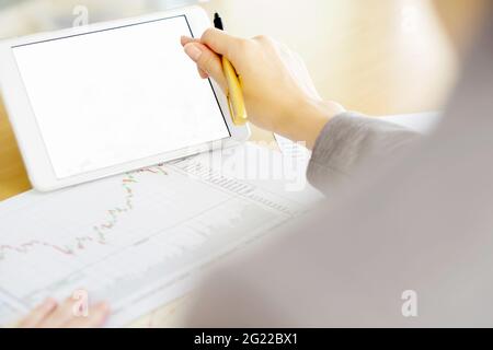 Close-up Of A Businesswoman Analyzing Graph On Digital Tablet Stock Photo