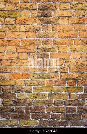 Yellow brickwall with rough textured surface Stock Photo