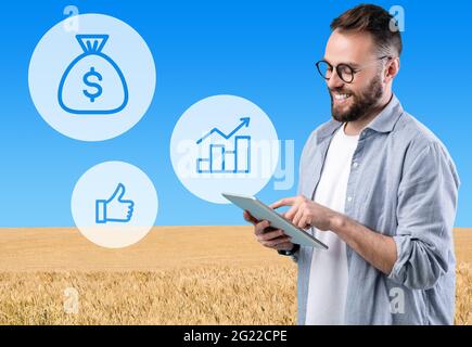 Millennial businessman using digital tablet while working on farm Stock Photo