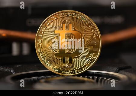 Gold bitcoin standing on crypto mining GPU computer hardware Stock Photo