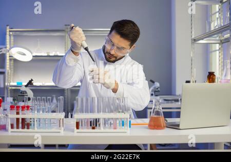 Serious scientist working alone in a pharma or biotech company science laboratory Stock Photo