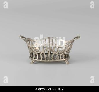 Basket. Openwork bread basket in Louis XVI style. The basket has two handles and stands on four legs. Guird builds are walking around the sawing. The bread basket has been marked: twice Mt. = CS in crowned heart. Stock Photo