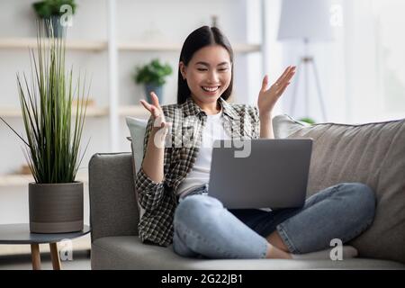 Happy asian woman having video chat with her lover Stock Photo