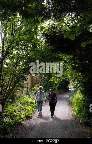 A mother and daughter walk along a country lane, on 30th May 2021, in Nailsea, North Somerset, England. Stock Photo