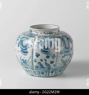 Melon-Shaped Jar. Egg-shaped pot of porcelain with a lobed wall, painted in underglaze blue. The wall is divided into compartments with a landscape with flowering plants, birds or mushrooms. Above the foot a tire with stylized leaf motifs. On the shoulder a bond with flower drinks. The neck with stylized flower drinks. Cracking porcelain in blue and white. Stock Photo