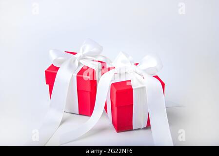 Two red gift boxes with white bows. Stock Photo