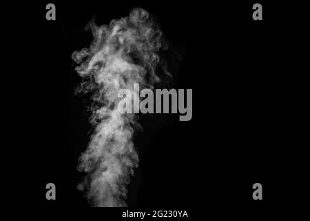 Perfect mystical curly white steam or smoke isolated on black background. Abstract background fog or smog, design element, layout for collages. Stock Photo