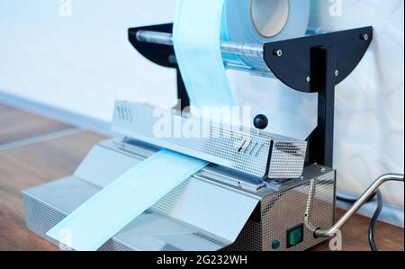 Apparatus for sealing steel medical instruments in separate sealed packages to maintain sterility before use in dental and medical practice. Special p Stock Photo