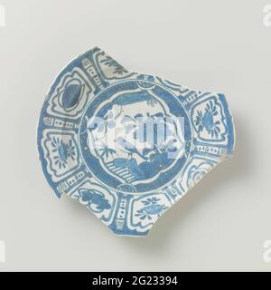 Fragment board from v.O.c.-ship the 'white lion'. Fragment board from v.o.c.-ship the 'white lion' with a flat edge and a scalloped lip, decorated in underglaze blue, 70%% present. On the flat a bird on a rock at a flowering plant, surrounded by an accolaneous band with geometric motifs. On the wall and edge alternately wide and narrow fields with lucky symbols and flower branches. Type 1.1.4a. Stock Photo