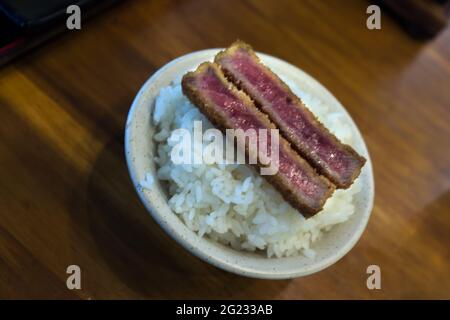 Fried crispy beef Gyukatsu steak served with rice Stock Photo