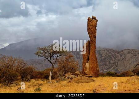 Guest farm Omandumba in the Erongo Mountains: Rain clouds over a rock needle (granite), rainy season, near Omaruru,  Erongo Region, Namibia Stock Photo