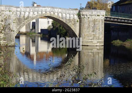 Medieval stone bridge over the river Gartempe in the middle of the town of Montmorillon, France Stock Photo