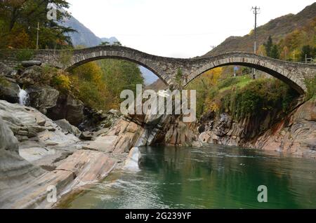 Ponte dei Salti, at Swiss Alps Valley with river between colorful trees and leaves, Ticino Valle Maggia, Maggiatal Stock Photo