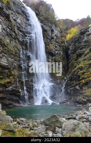 Waterfall at Ticino Valle Maggia, Maggiatal, Switzerland. At beautiful landscape scenery with colorful leaves, gras Stock Photo