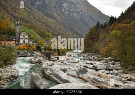 Village Town near Maggia river at Swiss Alps Valley, Ticino Valle Maggia, Maggiatal between mountains and autumn trees Stock Photo