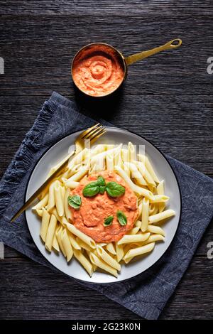 Parma Rosa Sauce with Penne on a plate on a dark wooden table Stock Photo -  Alamy