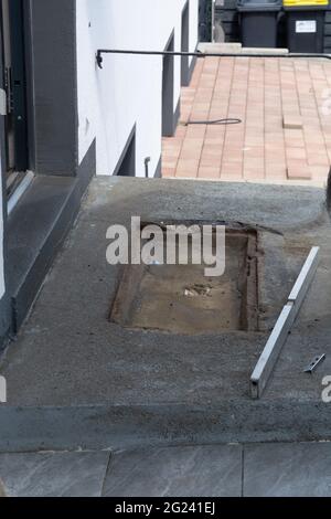 The construction worker evenly spreads the surface of the stairs with cement adhesive mass using a special hand tool. Stock Photo