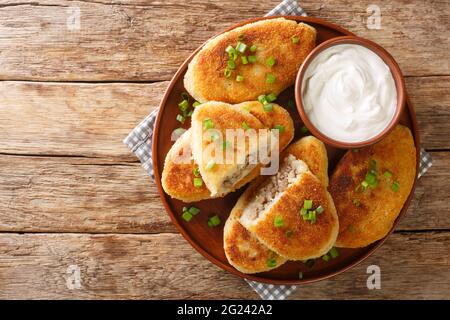 Traditional Ukrainian cuisine tasty Potato zrazy with meat close-up in a plate on the table. Horizontal top view from above Stock Photo