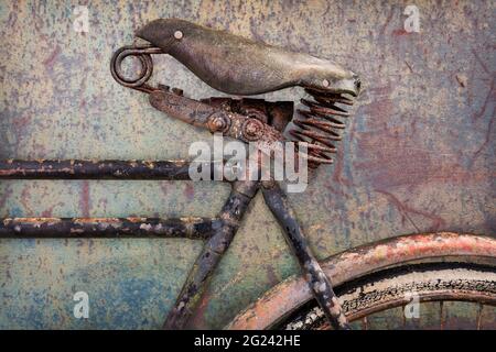Retro styled image of a rusted ancient bicycle with leather seat