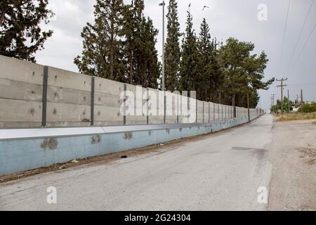 Thessaloniki, Greece. 07th June, 2021. View of a 3-meter grey wall constructed around the Diavata refugee camp near Thessaloniki. High concrete walls are being built around refugee camps on the Greek mainland and the Greek islands, a move Greece claims is for security purposes. Credit: SOPA Images Limited/Alamy Live News
