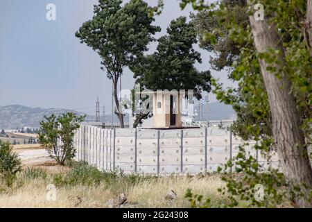 Thessaloniki, Greece. 07th June, 2021. View of a 3-meter grey wall constructed around the Diavata refugee camp near Thessaloniki. High concrete walls are being built around refugee camps on the Greek mainland and the Greek islands, a move Greece claims is for security purposes. Credit: SOPA Images Limited/Alamy Live News
