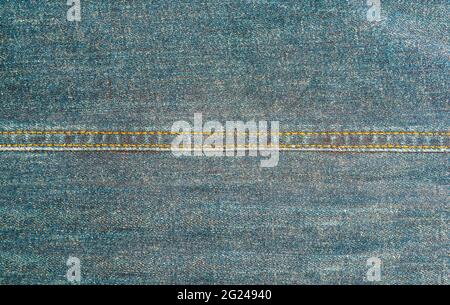 close-up view of worn blue denim fabric with double stitched seam, full-frame background Stock Photo