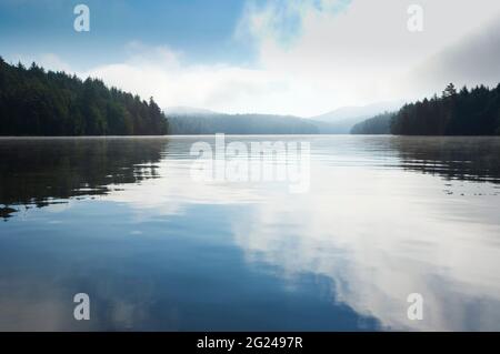 USA, New York, Tupper Lake, Clouds reflected in Saginaw Bay on Upper Saranac Lake Stock Photo