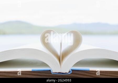 Book pages folded in heart shape Stock Photo