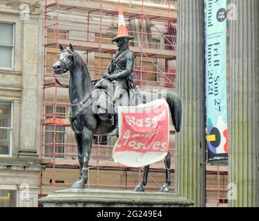 Glasgow, Scotland, UK, 8TH June, 2021. Level 2 lockdown saw a more normal return to life in the city. The cone headed man statue saw the latest priotest against council venues and libraries closures. Credit: Gerard Ferry/Alamy Live News Stock Photo