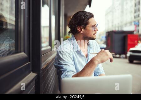 Close up of serious man being deep in thoughts Stock Photo