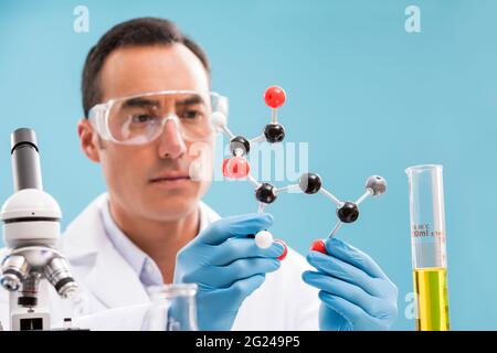 Scientist holding molecule model Stock Photo