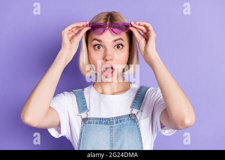 Photo of nice impressed short hairdo blond lady wear spectacles white t-shirt isolated on violet background Stock Photo
