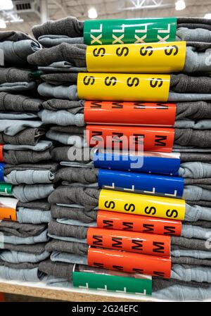 clothing store with a large assortment of pants and jeans hanging on ...