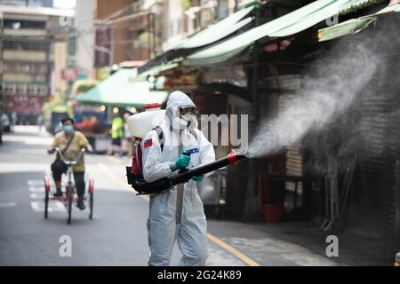 Taipei, Taiwan. 8th June, 2021. Soldiers spray disinfectant in a market in Taipei as Taiwan experiences its worst outbreak since the pandemic started. After experiencing a spike of local infections Taiwan's raised its alert to a Level-3, closing schools, recreational facilities and mandating take-out for restaurants. Face masks be worn in all public spaces. Credit: Brennan O'Connor/ZUMA Wire/Alamy Live News Stock Photo