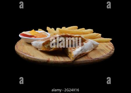 French tacos with chicken. Served with french fries, mayonnaise, ketchup and mustard on a black background Stock Photo