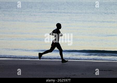 Miami-Sunny Isles-USA- 2-01-2016- An  African-American man runs at dawn on Sunny isles in Miami.FL. © JOSE ISAAC BULA URRUITA. Stock Photo