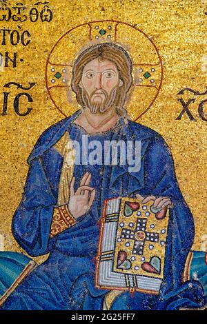 Detail of the Empress Zoe mosaic, Hagia Sophia (Turkish: Ayasofya), Istanbul, Turkey. Christ Pantocrator giving his blessing with the right hand and holding the Bible in his left hand. Clad in a dark blue robe, as is the custom in Byzantine art. Stock Photo