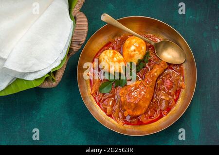 Nice Pathiri with chicken curry , malabar special food made using rice flour which is white round thin shape arranged on a banana leaf placed in a bas Stock Photo