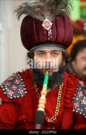 Turkish man donning an Ottoman outfit and smoking a hookah pipe, Istanbul, Turkey Stock Photo