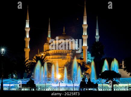 Sultan Ahmed Mosque (Turkish: Sultan Ahmet Camii), also known as the Blue Mosque. An Ottoman-era Friday mosque located in Istanbul, Turkey. Illuminated at night; colourfully-lit Sultan Ahmad Maydan water fountain Stock Photo