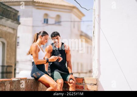 Couple using mobile phone after workout Stock Photo