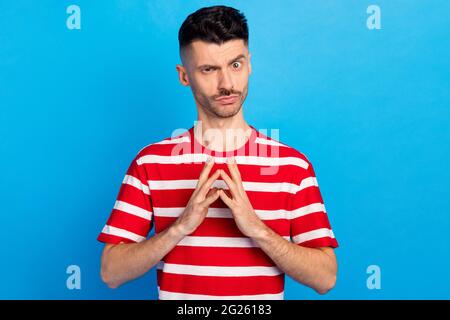 Photo of evil charming young man hold hands fingers together sneaky plan isolated on pastel blue color background Stock Photo