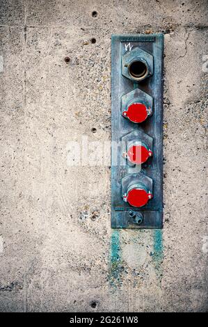 fire hose connectors on building wall Stock Photo