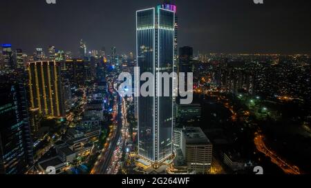 Aerial view of Architecture details Modern Building Glass facade Business background at night. Jakarta - Indonesia. June 9, 2021