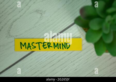 Mastermind write on sticky notes isolated on Wooden Table. Stock Photo