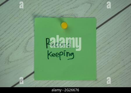 Record Keeping write on sticky notes isolated on Wooden Table. Stock Photo