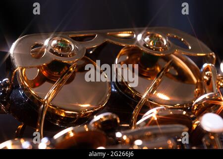 Light reflections on the valves of a brass instrument. Stock Photo